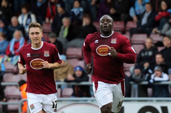 Adebayo Akinfenwa celebrates the first of his two goals against Wycombe on Saturday (Picture: Sharon Lucey)