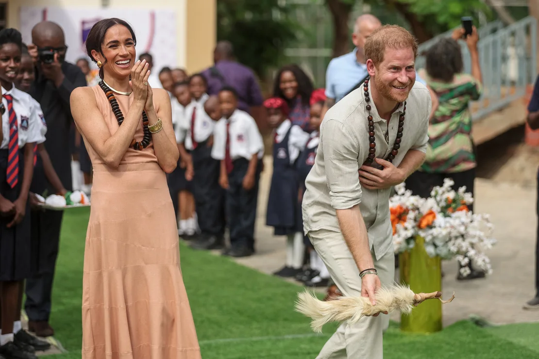 Britain's Prince Harry, Duke of Sussex, and Meghan, Duchess of Sussex, take part in activities as they arrive at the Lightway Academy in Abuja on May 10, 2024. Kola Sulaimon/AFP/Getty Images